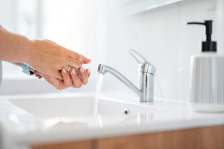 Woman Washing Hands In The Bathroom At Home Close-Upの写真素材