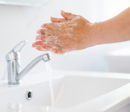 Woman Washing Hands In The Bathroom At Home Close-Upの写真素材