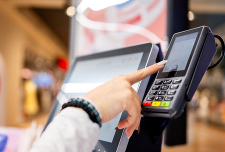 Close-Up Of A Girl Paying For Groceries At Self-Checkoutの写真素材