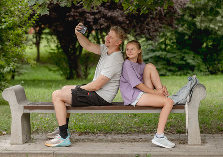 Dad And Daughter Spending Time Together Taking Selfies On A Walk