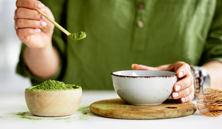 Process Of Making Matcha Tea Involves A Woman Pouring Tea Into A Bowlの写真素材