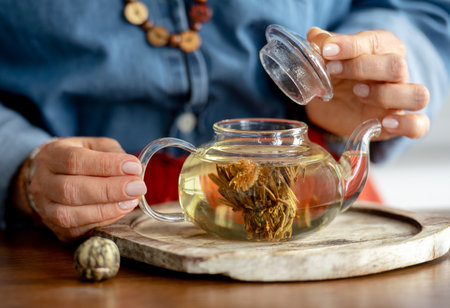 Woman Brewing Tied Green Tea In The Shape Of A Flower