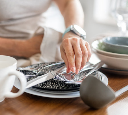 Woman Drying Dishes In The Kitchen At Homeの写真素材