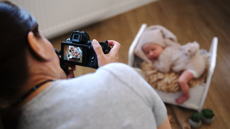 Newborn Photographer Taking Baby Pictures Backstage At A Newborn Photoshoot