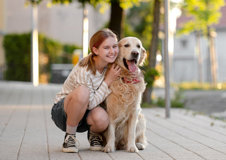 Happy Girl Hugging Golden Retriever Dog Outside