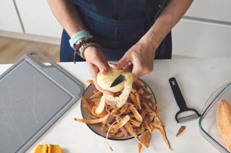 Woman Cleaning Potatoes Close-Up Top Viewの写真素材