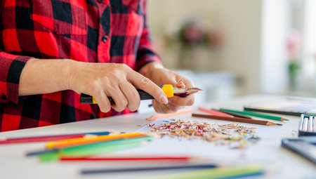 Close-Up Of A Woman Sharpening Colored Pencilsの写真素材