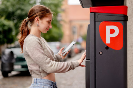 Young Woman With An Umbrella At The Parking Meterの写真素材