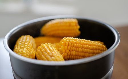 Raw Corn Cooking In Pot On Tableの写真素材
