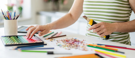 Close-Up Of A Woman Sharpening Colored Pencils