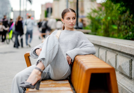 Model Posing While Sitting On A City Streetの写真素材