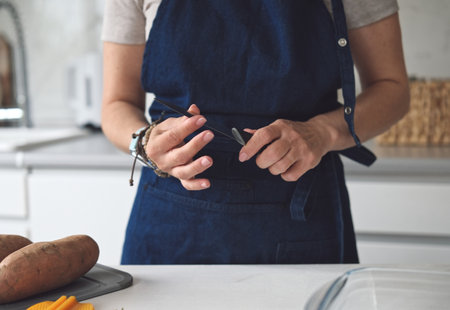 Close-Up Of Woman Checking Knife Sharpnessの写真素材