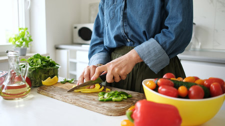 Woman Slicing Pepper For Saladの写真素材