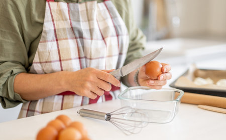 Close-Up Of A Woman Cracking An Egg For Baking