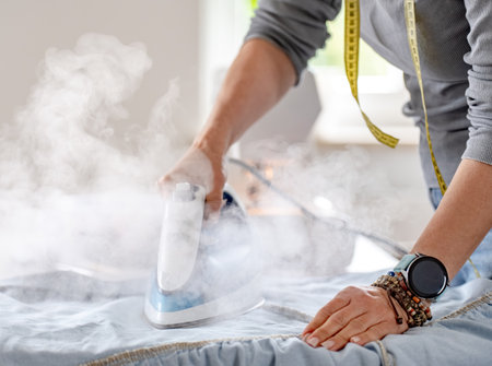 Woman Ironing Clothes With Steamの写真素材