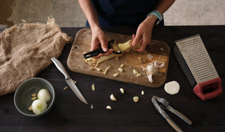 Close-Up Top View Of A Woman Peeling Gingerの写真素材