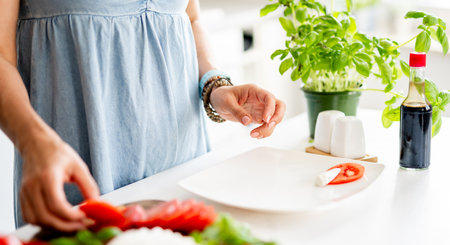 Close-Up Of Woman Making Caprese Saladの写真素材