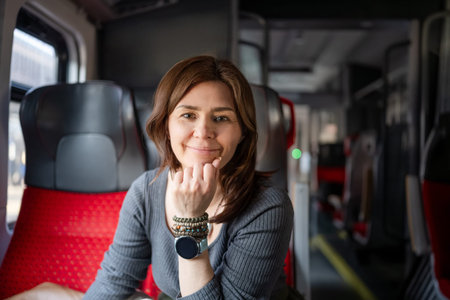 Young Woman Riding A Train And Smiling At The Camera