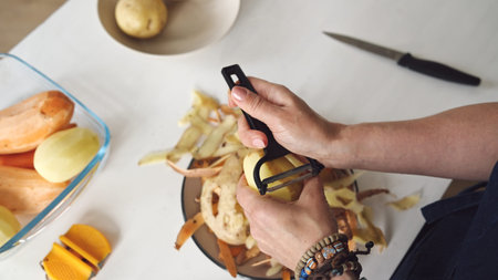 Woman Cleaning Potatoes Close-Up Top View
