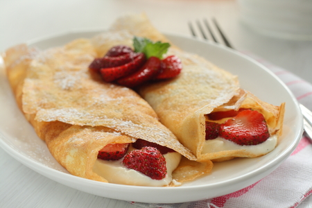 Crepes with strawberry jam and creamの写真素材