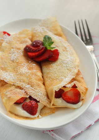 Crepes with strawberry jam and creamの写真素材