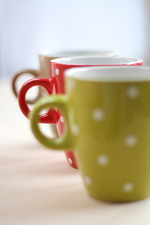 Colorful cups are fuzzy after each other in the light, like a fog backgroundの写真素材