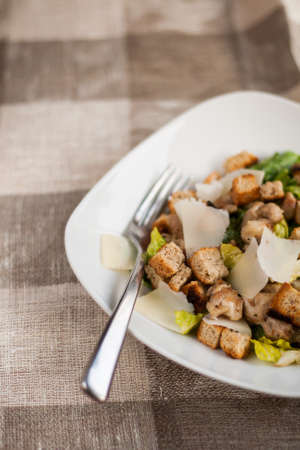 Caesar salad with chicken, lettuce and cheese.の写真素材
