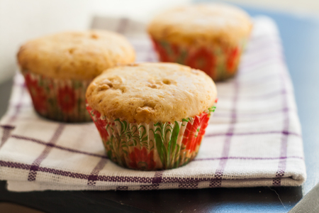 Vanilla Muffins cupcakes with white chocolate on a towel.の写真素材