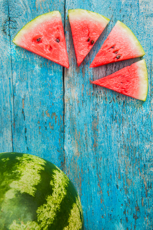 slice of watermelon on a blue background.の写真素材