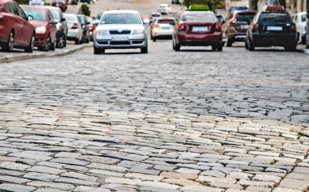 cars go on the road cobbles.の写真素材