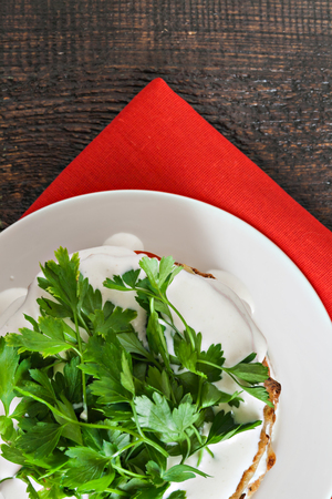 zucchini cake watered sauce on a red napkin on a blue wooden backgroundの写真素材