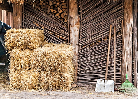 folded hay and shovel in the yard.の写真素材