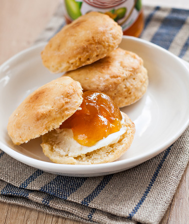 scones with butter and jam on a napkin and Bank of jam.の写真素材