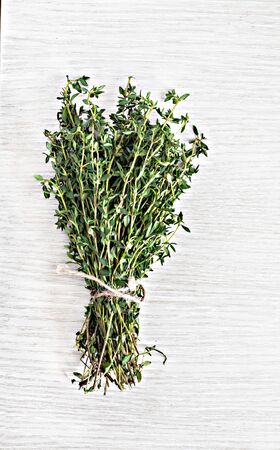 bunch of fresh estragon on a wooden table background.の写真素材