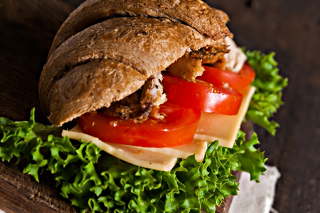 grain croissant sandwich on a whiteboard and a dark background.の写真素材