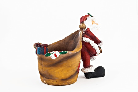 ceramic figurine of Santa Claus with a big sack isolated.の写真素材