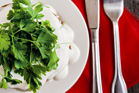 zucchini cake and eating utensils on a red napkin on a blue wooden backgroundの写真素材