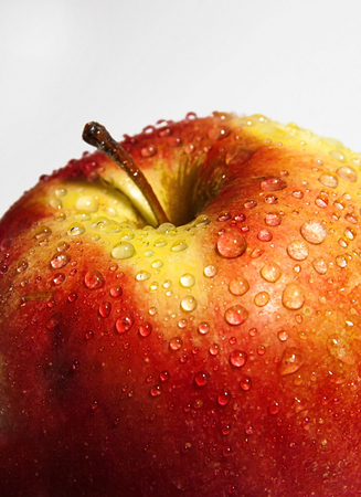 juicy red apple with drops close-up.の写真素材