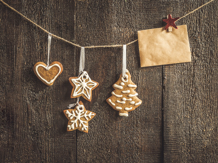 painted by ginger cookies and a blank card on a rope.の写真素材
