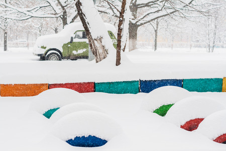 heavy snow fall asleep playground and car.の写真素材
