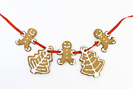 painted by ginger cookie on a tape isolated on fir branches.の写真素材