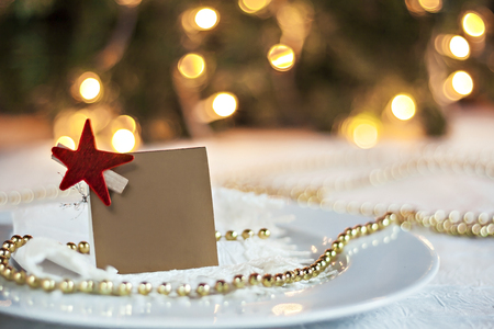 festive table decorated with Christmas balls and card for the wishes.の写真素材