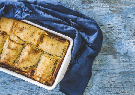 baked stuffed crepes on a blue background and an old blue napkin top viewの写真素材