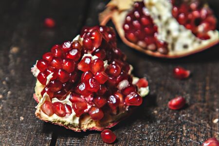 broken pomegranate close-up on a dark background.の写真素材
