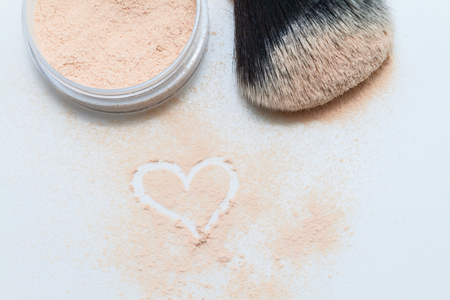 sprinkled powder, brush and drawing heart.の写真素材