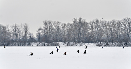 landscape fisherman on winter fishing far view.の写真素材