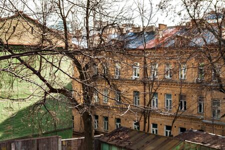 Through the branches of the trees of the old city of Kiev can see the roof.の写真素材