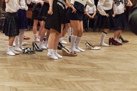 Ukraine.Kiev-May 19,2017.little girls show humorous performance in the adult shoes and hat.