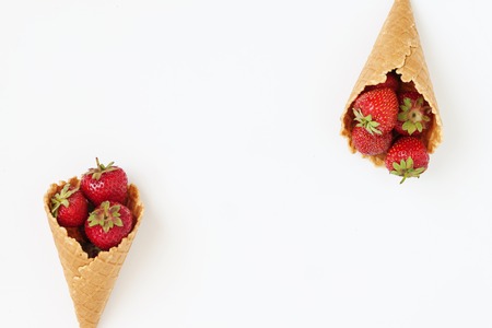 Waffle cone with fresh strawberries, top view, isolated on white background.の写真素材