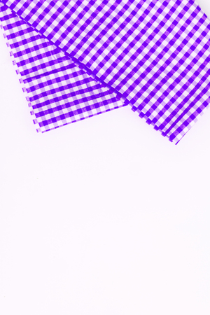Magenta, purple cloth, kitchen towel with checkered pattern, isolated on white background isolated.の写真素材